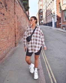 denim shorts styled with an oversized flannel and a belt bag